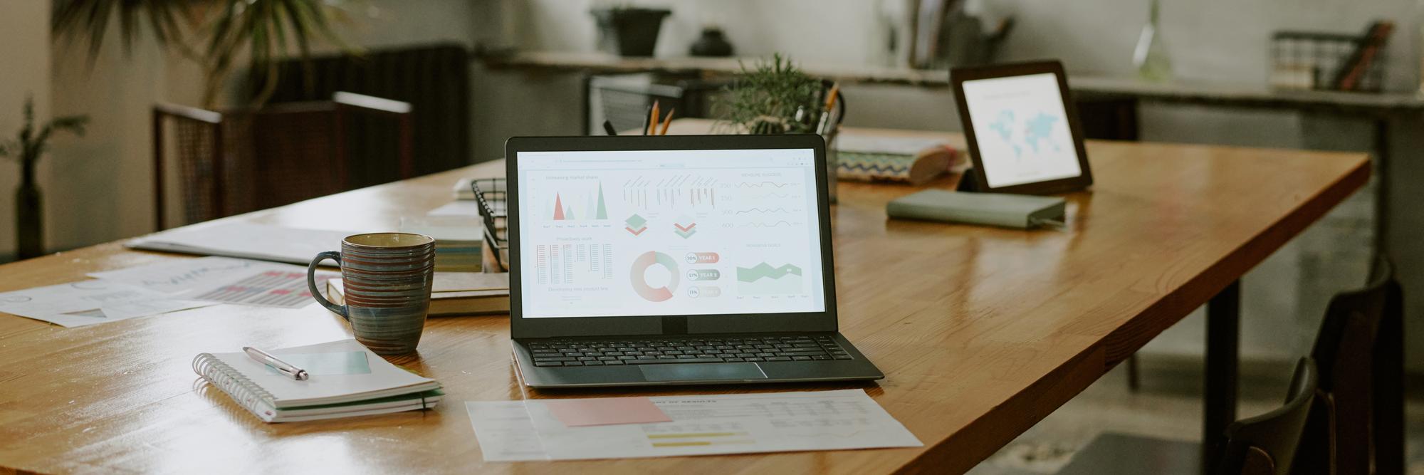 Workspace with financial charts and a laptop
